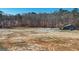 Scenic aerial view of the property featuring a blend of open land and picturesque woodland at 3630 Jim Moore Rd, Dacula, GA 30019