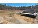 Aerial view showcasing the home, surrounded by a large, mostly cleared yard at 3630 Jim Moore Rd, Dacula, GA 30019