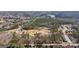 An overhead shot showcases the property's neighborhood surrounded by lush forestry and a scenic lake at 3630 Jim Moore Rd, Dacula, GA 30019