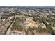 Expansive aerial view of the property, showcasing its serene wooded surroundings and potential for development at 3630 Jim Moore Rd, Dacula, GA 30019