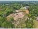 Expansive aerial view of wooded acreage, showcasing potential building sites and nearby luxury homes at 3630 Jim Moore Rd, Dacula, GA 30019
