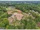 Expansive aerial view of wooded acreage, showcasing potential building sites and nearby luxury homes at 3630 Jim Moore Rd, Dacula, GA 30019