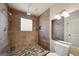 Bathroom showcasing tiled shower with glass block window and mosaic tile flooring at 3630 Jim Moore Rd, Dacula, GA 30019