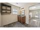 Bathroom featuring a granite countertop, dark cabinets, and built in shelving at 3630 Jim Moore Rd, Dacula, GA 30019