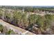 This image displays a long driveway and property entrance surrounded by a lush, green wooded area at 3630 Jim Moore Rd, Dacula, GA 30019