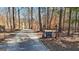 Gated driveway entrance surrounded by mature trees offering privacy and security at 3630 Jim Moore Rd, Dacula, GA 30019