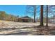Charming home with a welcoming porch, expansive yard, and a serene wooded backdrop at 3630 Jim Moore Rd, Dacula, GA 30019