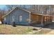 Back exterior of home with wood siding and covered porch at 3630 Jim Moore Rd, Dacula, GA 30019