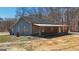 Charming single-story home featuring a covered front porch, gray siding, and a satellite dish in a natural setting at 3630 Jim Moore Rd, Dacula, GA 30019