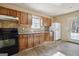 Kitchen featuring traditional cabinetry, tile backsplash and black appliances at 3630 Jim Moore Rd, Dacula, GA 30019