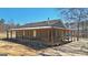 Exterior rear view of home with covered porch and rustic charm at 3630 Jim Moore Rd, Dacula, GA 30019