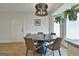 Elegant dining area with stylish chandelier, table setting, and natural light at 203 Hedgewood Ct, Peachtree City, GA 30269