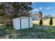 Backyard featuring a storage shed, partial fence, and a view of the house at 170 Cobblestone Ct, Douglasville, GA 30134