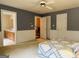 Spacious bedroom featuring a ceiling fan, and view into the ensuite bathroom at 9255 Betony Wood Trl, Jonesboro, GA 30236