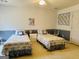 This secondary bedroom has two beds and a matching chest of drawers at 9255 Betony Wood Trl, Jonesboro, GA 30236