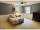 Bedroom featuring light blue walls, hardwood floors, a full-size bed, and a ceiling fan at 9255 Betony Wood Trl, Jonesboro, GA 30236