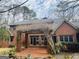 Brick home has a back patio, a large backyard and mature trees at 9255 Betony Wood Trl, Jonesboro, GA 30236