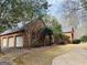 This brick home has a three-car garage, and well-kept lawn and landscaping at 9255 Betony Wood Trl, Jonesboro, GA 30236
