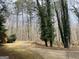 This single Gathering house boasts a winding driveway and mature trees at 9255 Betony Wood Trl, Jonesboro, GA 30236