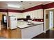 Bright kitchen with white cabinetry, hardwood floors, and an open layout, perfect for cooking and entertaining guests at 9255 Betony Wood Trl, Jonesboro, GA 30236