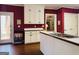 A traditional kitchen with white cabinetry, wood countertops and dark red walls at 9255 Betony Wood Trl, Jonesboro, GA 30236