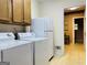 Laundry room with washer, dryer, refrigerator, and door leading to the interior of the home at 9255 Betony Wood Trl, Jonesboro, GA 30236