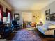 Elegant living room featuring hardwood floors, a decorative rug, and classic furnishings, offering a comfortable and stylish space at 9255 Betony Wood Trl, Jonesboro, GA 30236