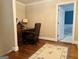 Office space showcasing a wood desk, wood floors, and an area rug at 9255 Betony Wood Trl, Jonesboro, GA 30236
