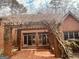 Back of the home featuring a brick patio, pergola, and outdoor seating at 9255 Betony Wood Trl, Jonesboro, GA 30236