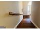A staircase with wood stairs, a wood handrail, and a neutral colored walls at 9255 Betony Wood Trl, Jonesboro, GA 30236