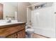 Bathroom featuring a white tub, tile floors and a wood vanity with crystal faucet handles at 5365 Renault St, Cumming, GA 30041