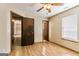 Bedroom featuring hardwood floors, ceiling fan, and view of a closet through the open door at 5365 Renault St, Cumming, GA 30041