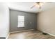 Bedroom with gray walls, wood floors, and ceiling fan at 5365 Renault St, Cumming, GA 30041