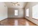 Bedroom with natural light from two windows, a ceiling fan, and durable wood laminate flooring at 5365 Renault St, Cumming, GA 30041