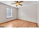 Bright bedroom with natural light, wood laminate flooring, and a ceiling fan at 5365 Renault St, Cumming, GA 30041