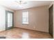 Bedroom featuring wood laminate flooring, a door to the exterior, and a window for natural light at 5365 Renault St, Cumming, GA 30041