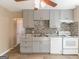 Kitchen featuring gray cabinets, modern appliances, stylish tile backsplash and hardwood floors at 5365 Renault St, Cumming, GA 30041