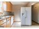 Spacious kitchen featuring ample counter space, stainless steel sink, white refrigerator and tile flooring at 5365 Renault St, Cumming, GA 30041