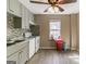 Updated kitchen featuring grey cabinets, modern appliances, and a stylish mosaic tile backsplash at 5365 Renault St, Cumming, GA 30041