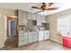 Updated kitchen featuring gray cabinets, modern appliances, mosaic backsplash and hardwood floors at 5365 Renault St, Cumming, GA 30041