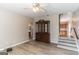 Living room with hardwood floors, ceiling fan, and a large cabinet, with a glimpse of the adjacent kitchen at 5365 Renault St, Cumming, GA 30041