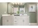 This bathroom has double sinks and a large mirror perfect for couples or families at 588 Parnassus Road, Locust Grove, GA 30248