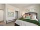 Bright bedroom featuring a decorative bed, bench, and natural light at 588 Parnassus Road, Locust Grove, GA 30248