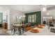Dining area with a rustic table, stylish chairs, modern lighting, and a view of the kitchen island at 588 Parnassus Road, Locust Grove, GA 30248