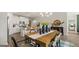 Open-concept dining area adjacent to a modern kitchen with a large island and bar seating at 588 Parnassus Road, Locust Grove, GA 30248