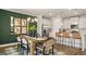 Stylish dining room featuring an elegant light fixture and seamless access to the modern kitchen at 588 Parnassus Road, Locust Grove, GA 30248