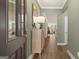 Inviting foyer with wood floors, elegant mirror and decor, offering a glimpse into the open-concept living space at 588 Parnassus Road, Locust Grove, GA 30248