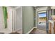 Bright foyer showcasing a view of the front yard and a glimpse of the bathroom with a striped shower curtain at 588 Parnassus Road, Locust Grove, GA 30248