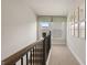 Hallway upstairs with a light brown carpet and multiple decorative wall frames next to a window at 588 Parnassus Road, Locust Grove, GA 30248