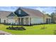 Traditional-style new construction home features manicured lawn, brick accents, and a two-car garage at 588 Parnassus Road, Locust Grove, GA 30248